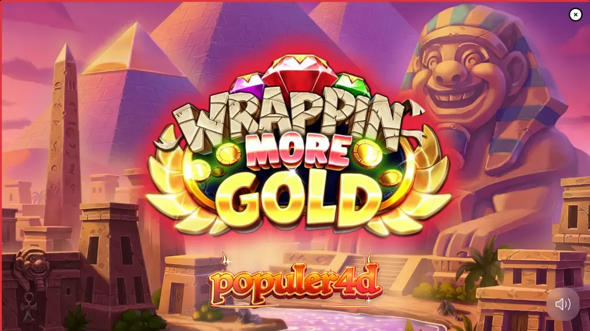 Tampilan layar permainan slot Wrappin’ More Gold dengan mumi ramah dan latar belakang gurun.